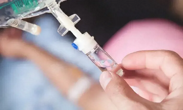 A patient receiving an IV infusion treatment