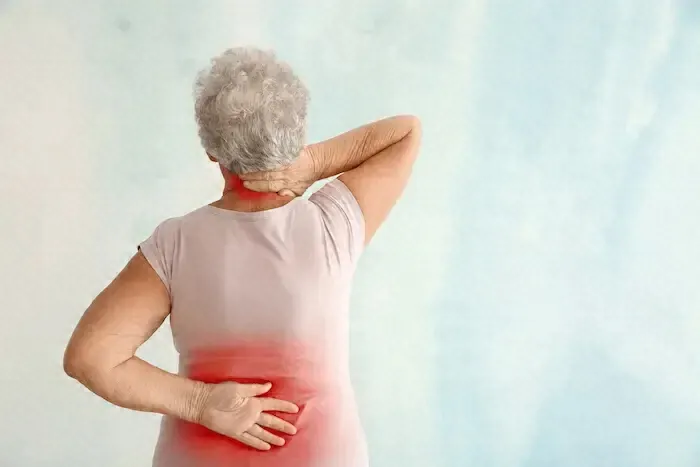 Woman stretching her back at home